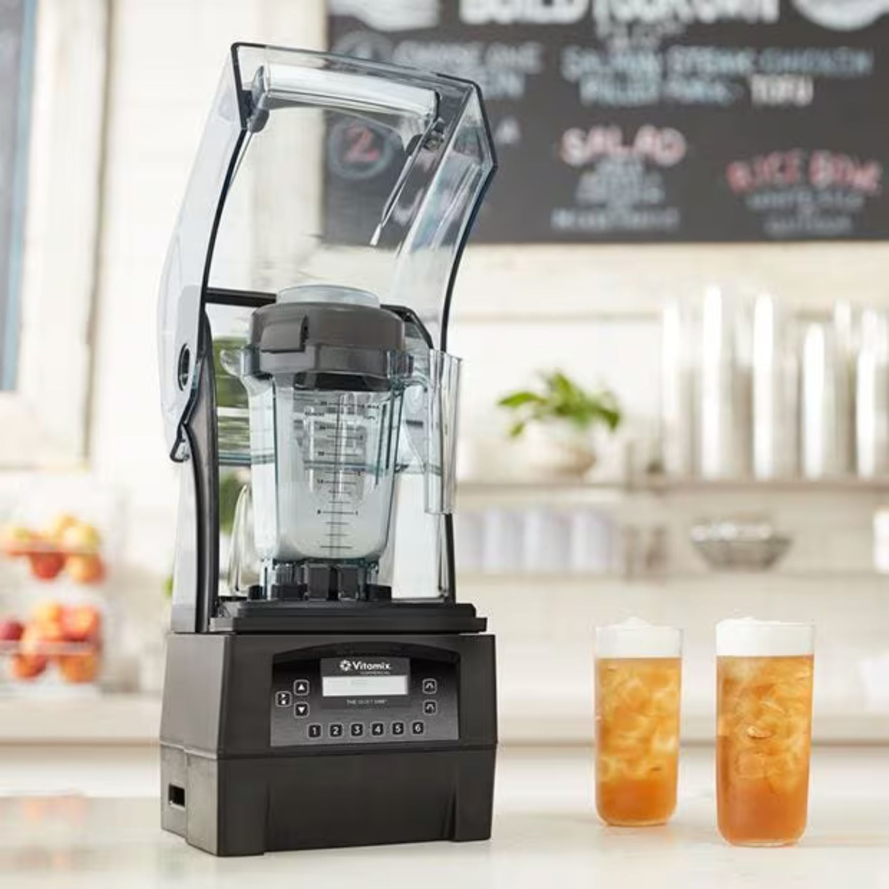 Blender on a counter with two glasses of iced tea in a kitchen setting