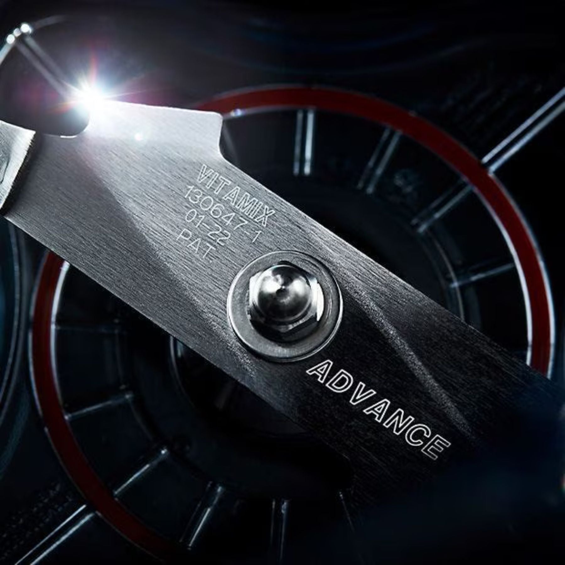 Close-up of a tool with 'Vitamix' branding and 'Advance' text against a dark background.