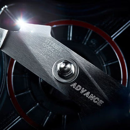 Close-up of a tool with 'Vitamix' branding and 'Advance' text against a dark background.