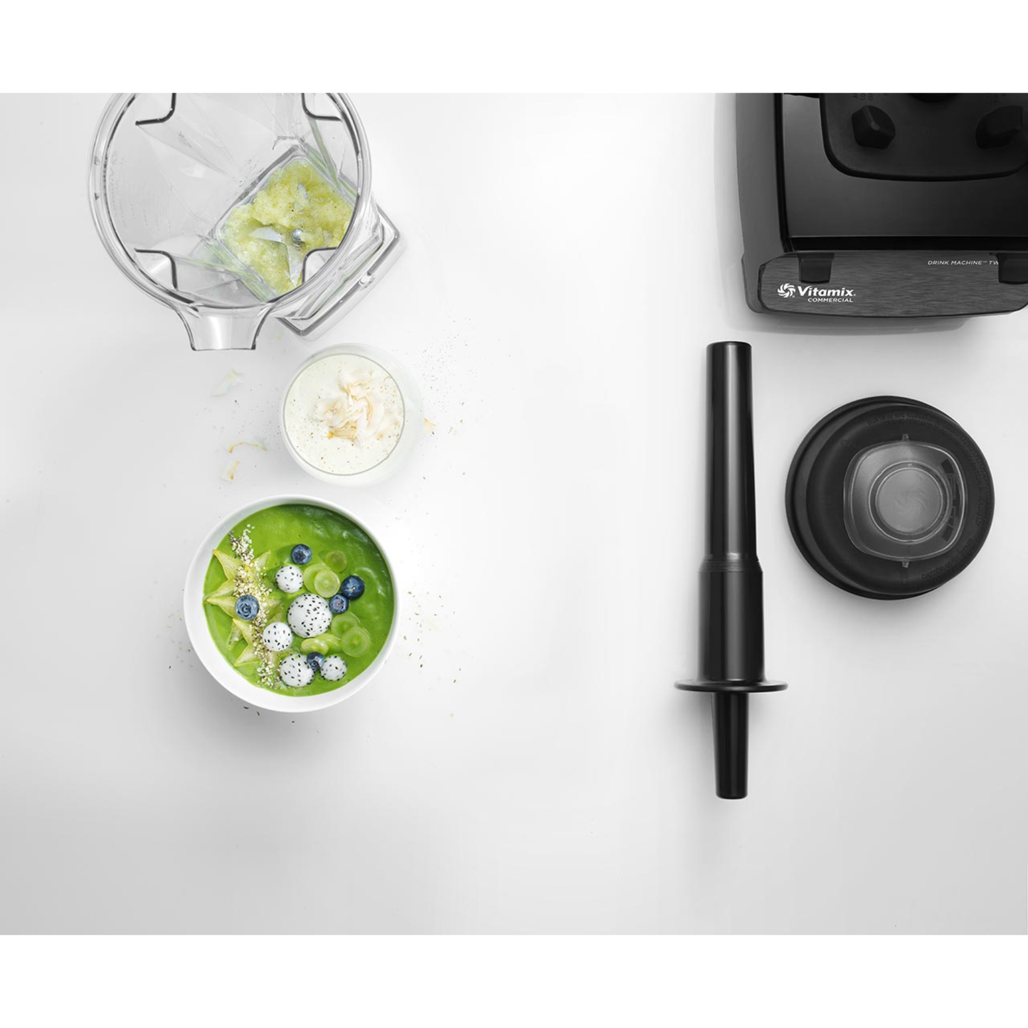 Vitamix Drink Machine Two-Speed 1.4L | Blenders Direct with a green smoothie and ingredients on a white surface