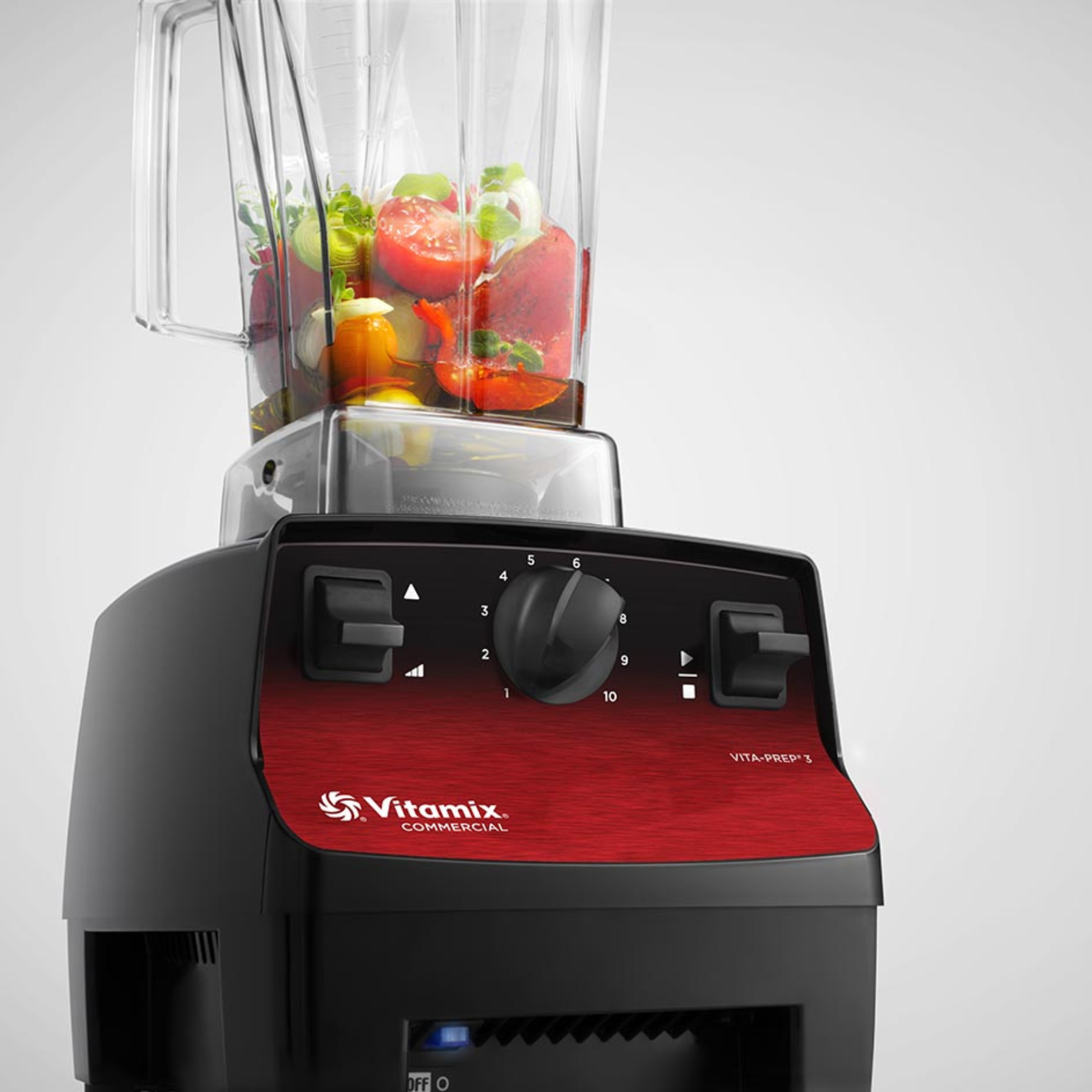 Vitamix Vita-Prep 3 | Blenders Direct with a red base and clear container filled with fruits and vegetables on a white background
