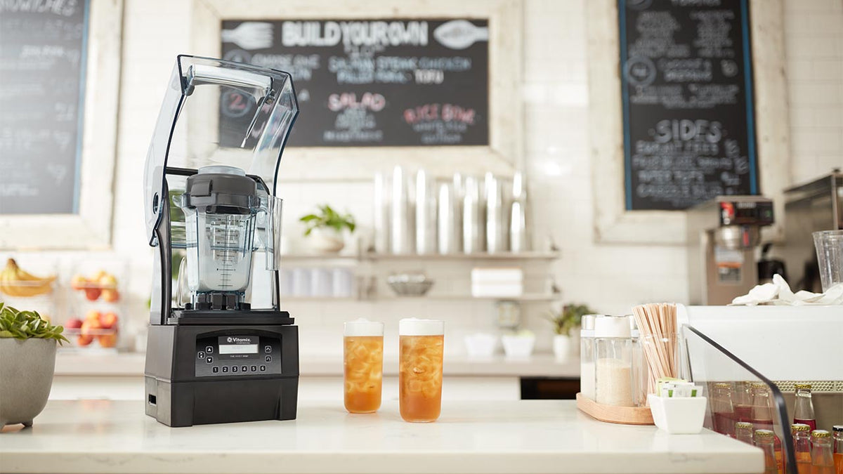 Vitamix Blender on a counter with a coffee shop background | Blenders Direct